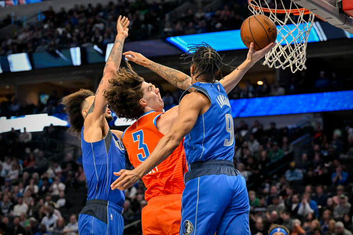 Mavs’ AJ Lawson and Dereck Lively II contend a layup from Thunder’s Josh Giddey.